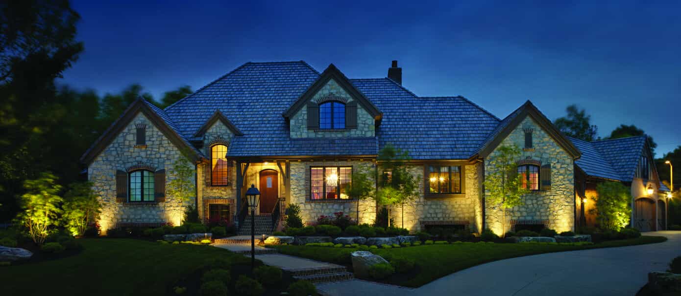stone house with outdoor lighting